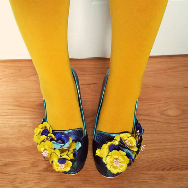 Irregular Choice flower embellished shoes close up detail of flowers on blue shoes worn with mustard tights