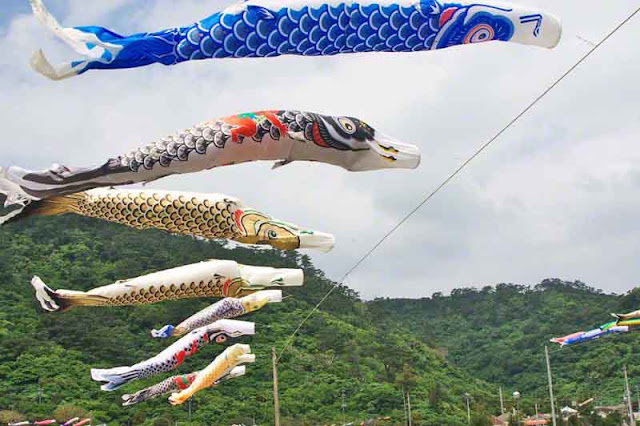 bright-colored carp streamers, hills, sky