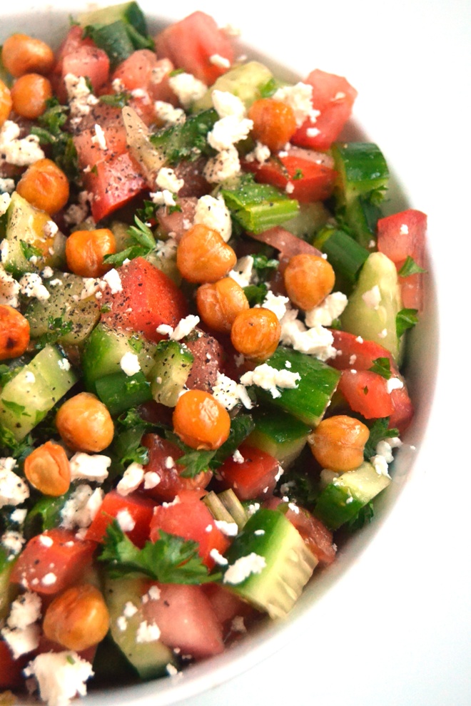 Greek Chopped Salad with Roasted Chickpeas is so delicious with chopped cucumber, tomato, green onion, parsley, feta cheese, crunchy roasted chickpeas and a fresh lemon vinaigrette for a delicious, nutritious side dish! www.nutritionistreviews.com