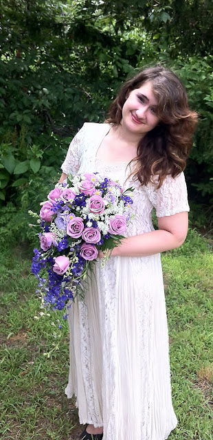 A bridal cascade of purple and lavender blooms by Stein Your Florist Co.