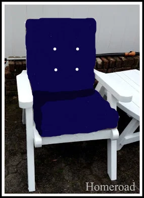White patio chair with blue cushion