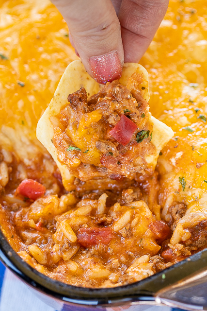 Enchilada Dipping Rice - seriously delicious!! Serve as a dip with chips or as a main dish. Everyone LOVES this yummy Mexican casserole!!! Ground beef, taco seasoning, enchilada sauce, cheese soup, refried beans, rice and cheese. Can make in advance and refrigerate until ready to bake. We make this at least once a month! SO good!!! #mexican #casserole #dip Enchilada Dipping Rice - seriously delicious!! Serve as a dip with chips or as a main dish. Everyone LOVES this yummy Mexican casserole!!! Ground beef, taco seasoning, enchilada sauce, cheese soup, refried beans, rice and cheese. Can make in advance and refrigerate until ready to bake. We make this at least once a month! SO good!!! #mexican #casserole #dip