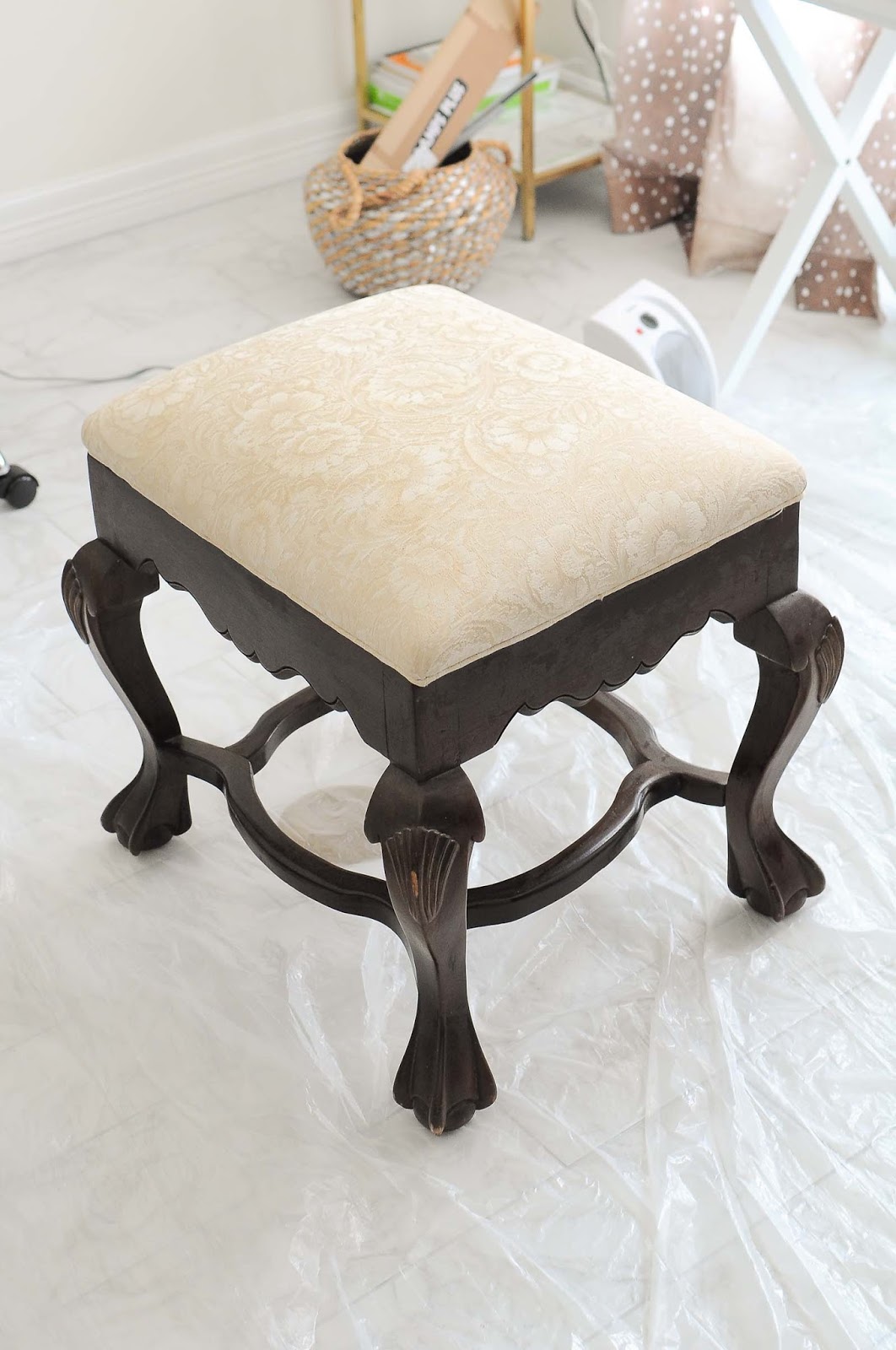 A thrift store ottoman gets a DIY black and gold makeover (even the fabric!) using Velvet Finishes paint.