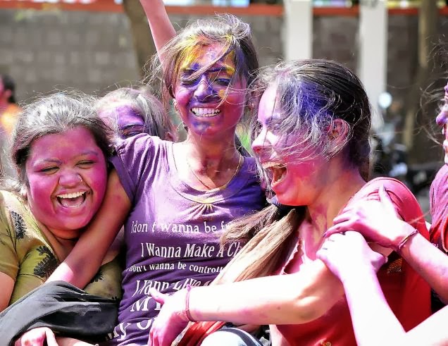 Girls enjoying on Holi with Colours and waters