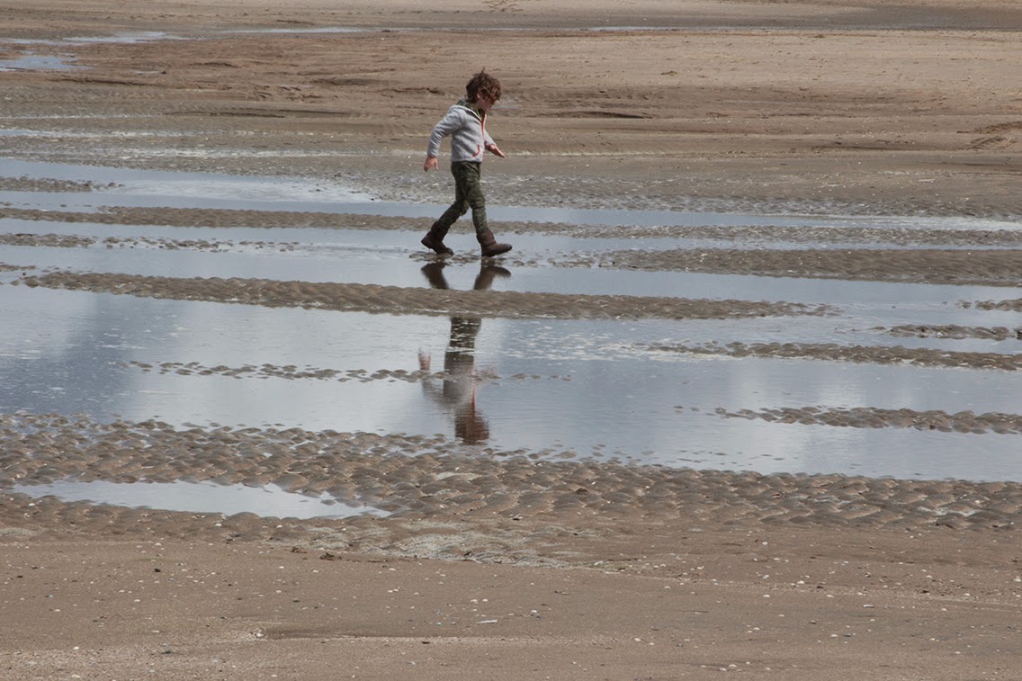 boy walking through water