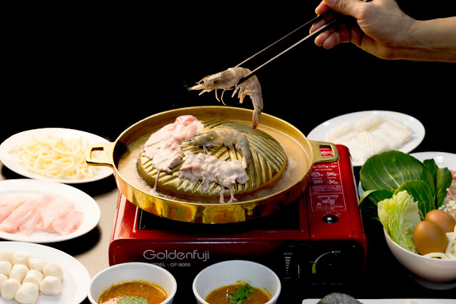 Food Photography: Chopsticks with Raw Prawn Photo of someone using chopstick to grab raw prawn