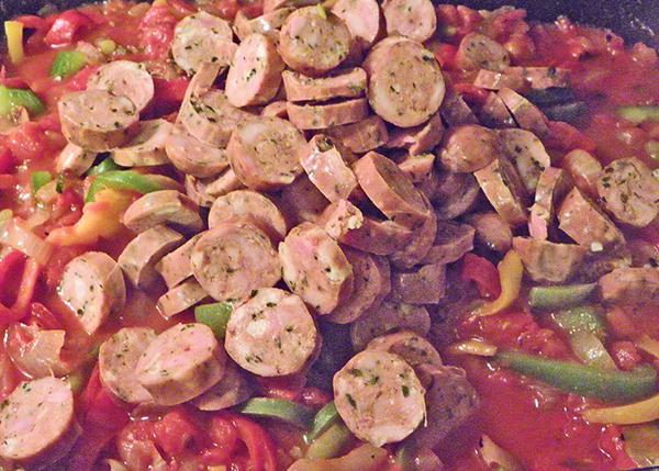 frying peppers and tomatoes with added sausage