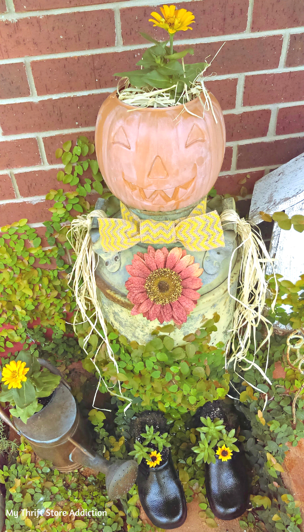 Repurposed vintage milk can scarecrow