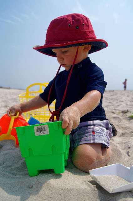 baby building sand castle