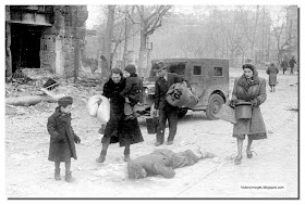 German women walk past dead soldier 1945