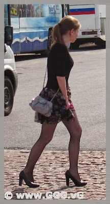Girl in black mini skirt on the street