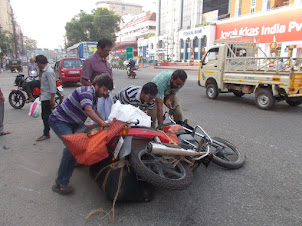 Lucky escape :- Collapse of overloaded motorcycle on "Marine Drive  road" of Ernakulam in Kochi.