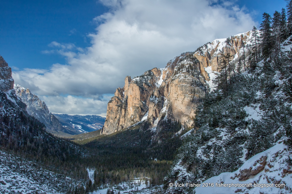 Italy Northern Dolomites snow mountains trees valley scenic landscape conifer fir red rock cliffs