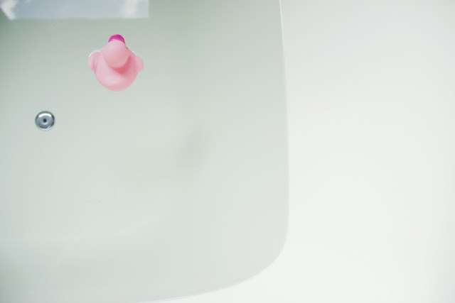 Bubble bath with a pink rubber duck