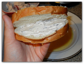 holding a piece of the bread with filling inside of bread with the cream cheese mixture 