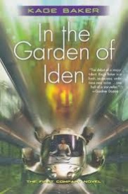 Cover of In the Garden of Iden, featuring a white spaceship zipping directly at the viewer through a blurred green background. An indistinct, white-clad figure sits at the small cockpit's controls. A blurred orange face hovers above the ship.