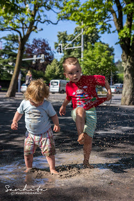 Two babies jumping and enjoying the muddy puddle