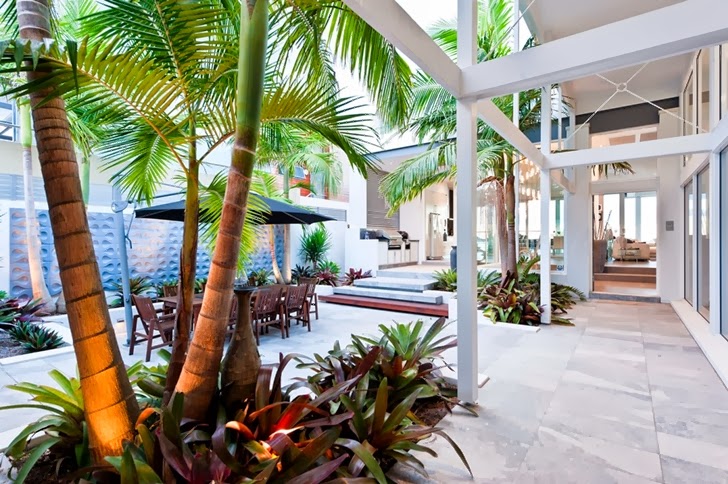 Backyard terrace in Coastal Oasis landscape project by Urban Exotic