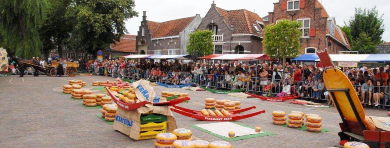 Traditional Dutch cheese market with Edam cheese wheels
