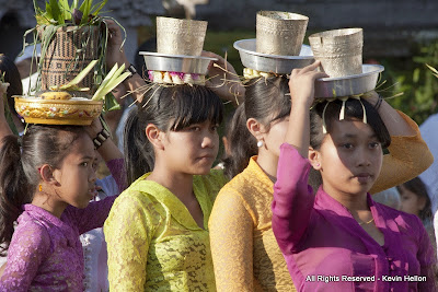 Balinese girls carry offerings to the temple during the Galungal festival, Bali