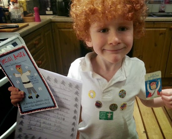 6 year old with lots of class stickers for achievement