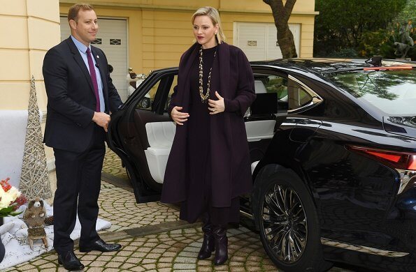 Princess Charlene wore a wool cashmere brown coat and brown long sleeve wool midi dress by Louis Vuitton