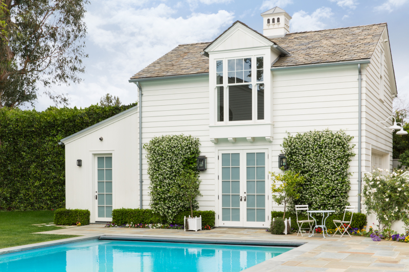 Pool house exterior - Cliffwood project by Steve Giannetti Exterior of white pool house studio at traditional California home