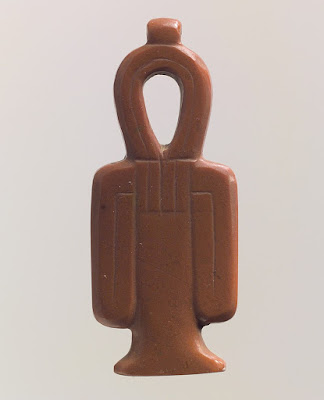 A tyet amulet, also known as the Knot of Isis. New Kingdom, Abydos, Egypt