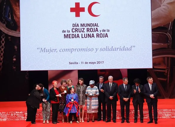 Queen Letizia wore Carolina Herrera Prince Of Wales Floral Cutout Dress. Letizia wore Magrit pumps at Red Cross Day event