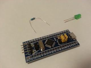 A current limiting resistor, an LED, STM32 board