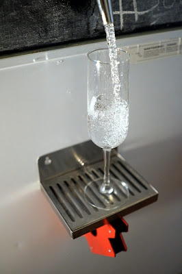 Pouring a glass of carbonated water from the tap!