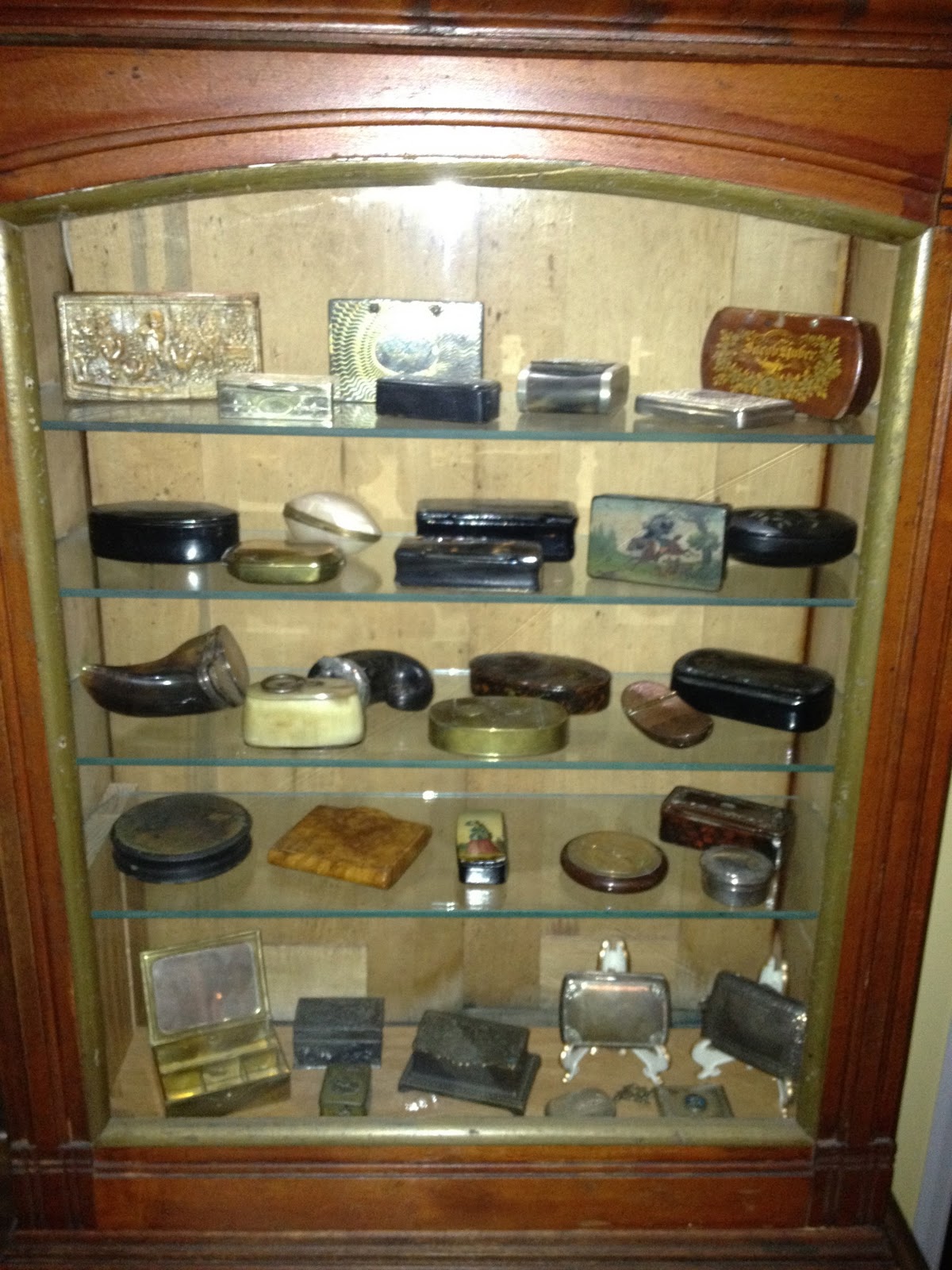 Antique Hunter Displaying a Collection of Snuff Boxes