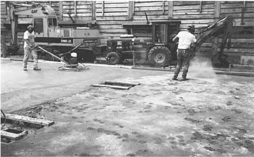 Dry-shake application of crystalline cementitious waterproofing.