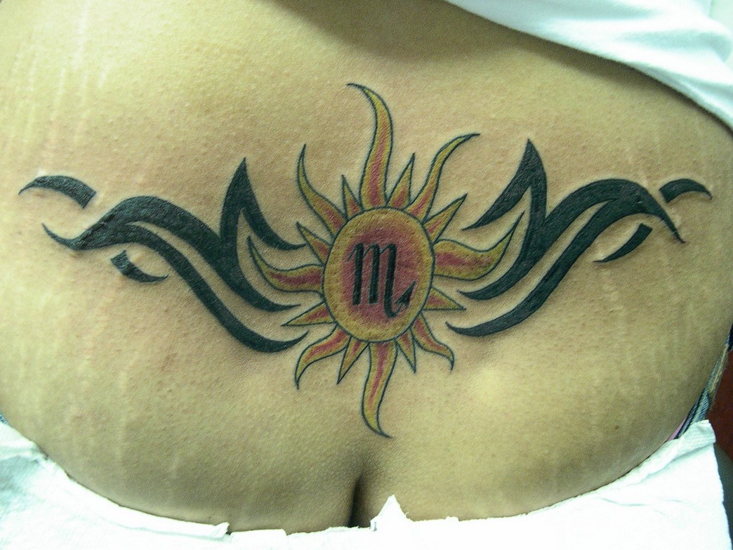 tribal+lower+back+tattoos+Lower+back+sun+and+tribal+tattoo+design.jpg