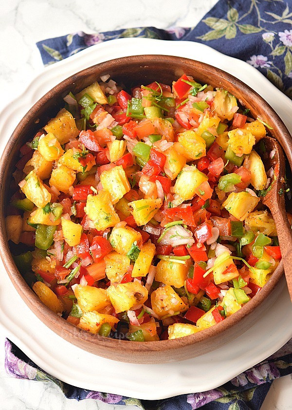 easy pineapple salsa served in a wooden bowl