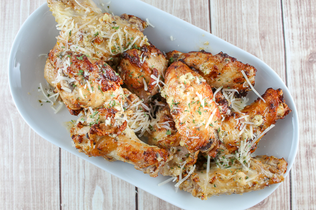 Garlic Parmesan Chicken Wings are my FAVORITE - I used to order them all the time from the pizza place up the street - but not any more! Now I make them at home in less time than the pizza delivery! These Air Fryer Garlic Parmesan Chicken Wings are the perfect dinner or party appetizer! #garlicparmesan #chickenwings #airfryer