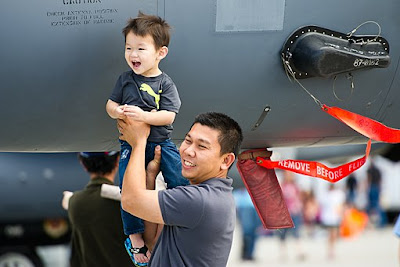 Father holds up child father-holds-up-child