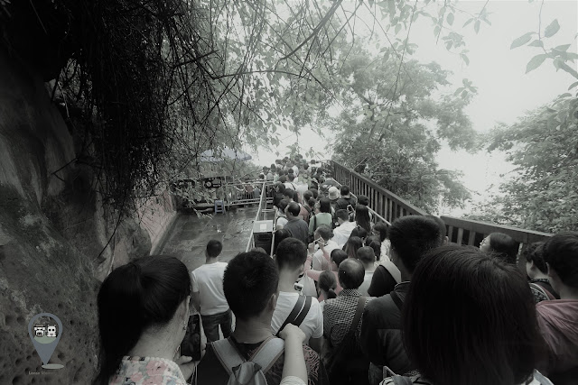Walking down the stairway slowly while admiring Leshan Giant Buddha in Sichuan province of China Walking down the stairway slowly while admiring Leshan Giant Buddha in Sichuan province of China