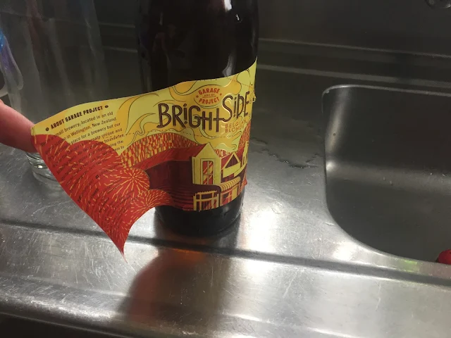 peeling off the beer label