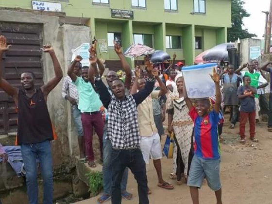 1 Photos: Ekiti state residents cheer Fayose as he walks on the street