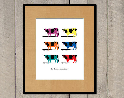 framed poster with multiple colored cows in complementary colors