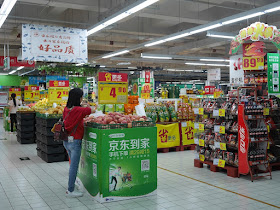 woman choosing apples at a Carrefour in Zhongshan, China