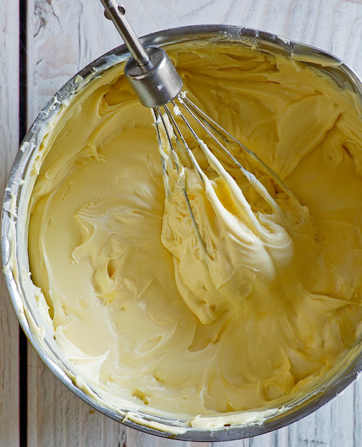 This Maple Buttercream is the best ever! It's not too sweet and has just enough maple. It is cream, smooth and buttery in the best kind of way. You have to try it! mixing bowl full of rich and creamy french maple buttercream