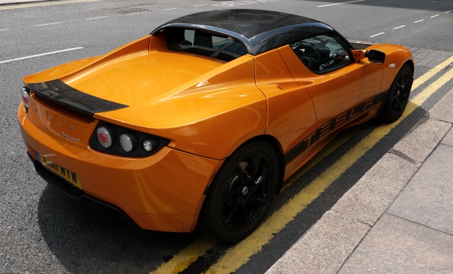 Orange Tesla Roadster Sport seen from the rear