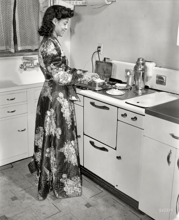 Winter 1942. Washington, D.C. Jewel Mazique, worker at Library of Congress, getting a late snack