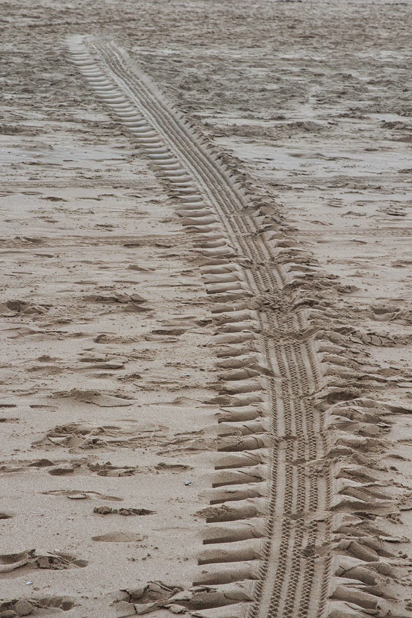 car tracks in sand