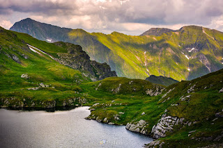  lake in mountains with grass on hillside