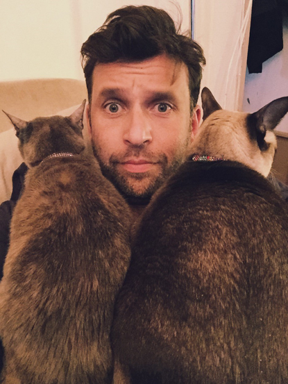 man with two brown cats sitting on his chest man with two brown cats sitting on his chest