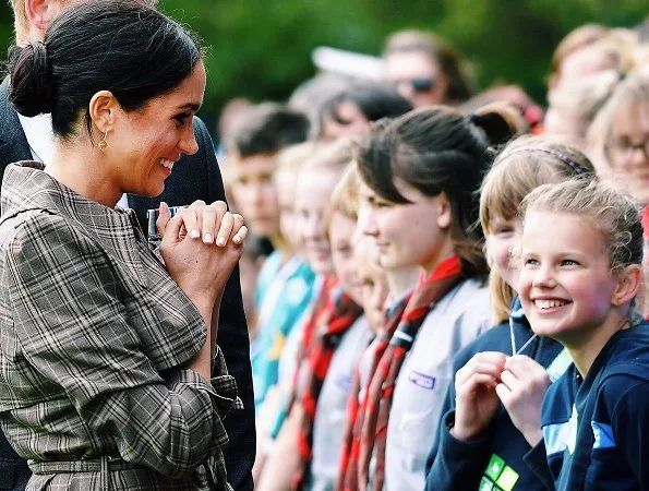 Meghan Markle wore Karen Walker Banks coat, Asos Design Maternity dress, Sarah Flint pumps and Birks Musecitrine and diamond drop earrings