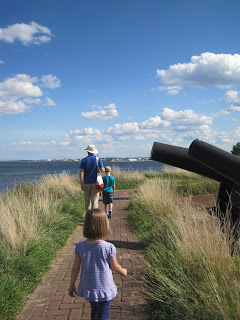 Three people walking the battlements